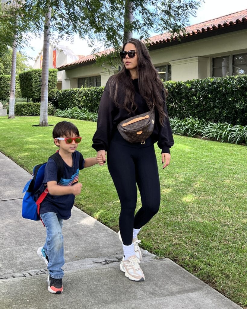 Monti Wheeler with her kid while using the Louis Vuitton Bumbag